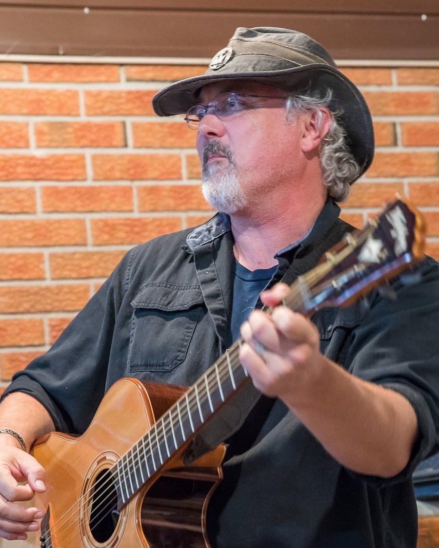 Mark McKechnie with his acoustic guitar